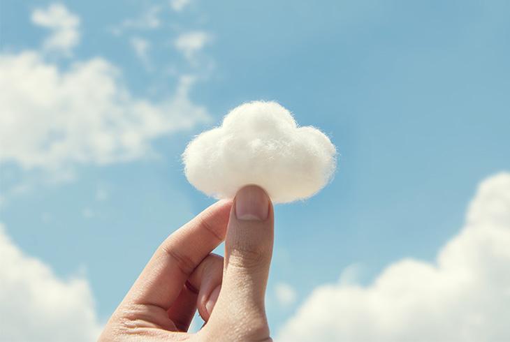 A hand holds a cloud between its fingers.