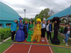 ladies in costumes representing the four elements and populair team