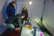 Team at the tent checking the results